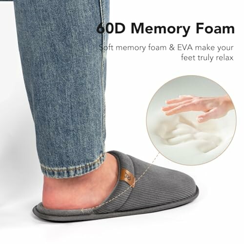 Person wearing gray memory foam slippers with jeans.